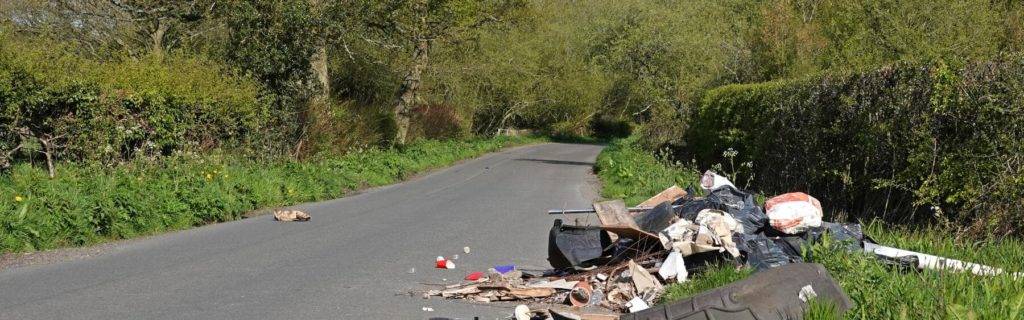 Fly tipping waste by the side of the road